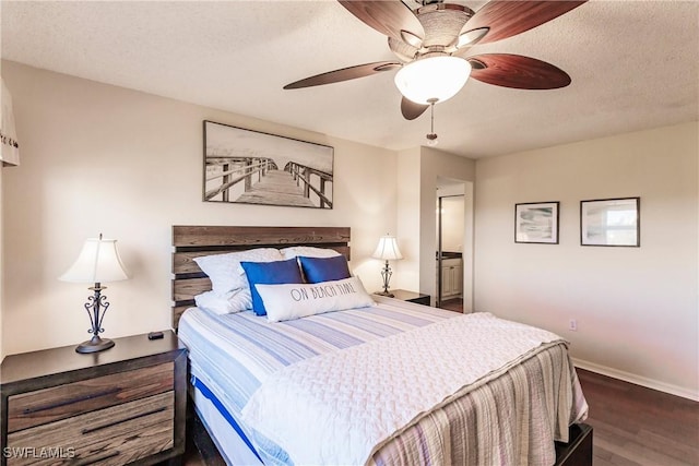 bedroom featuring ceiling fan, dark hardwood / wood-style flooring, a textured ceiling, and connected bathroom