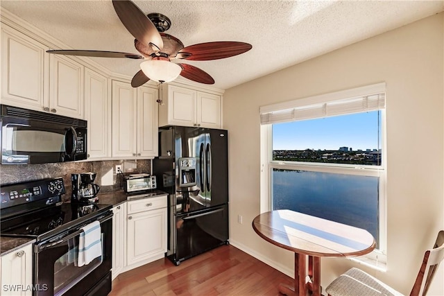 kitchen with black appliances, dark hardwood / wood-style floors, ceiling fan, a textured ceiling, and tasteful backsplash