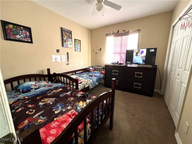 carpeted bedroom featuring ceiling fan and a closet