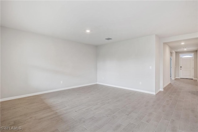 spare room featuring light wood-type flooring