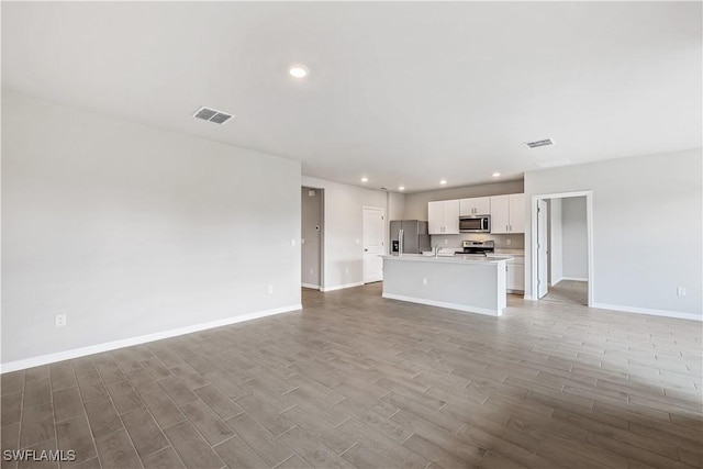 unfurnished living room with sink