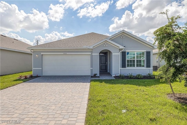 ranch-style house with a garage, central AC unit, and a front lawn