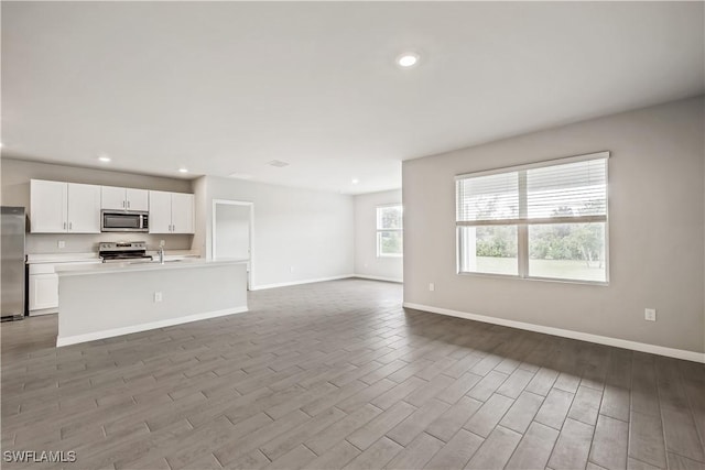 unfurnished living room with sink