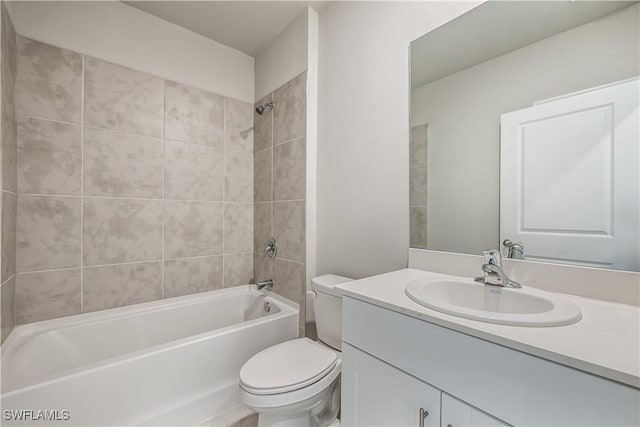 full bathroom featuring vanity, tiled shower / bath combo, and toilet