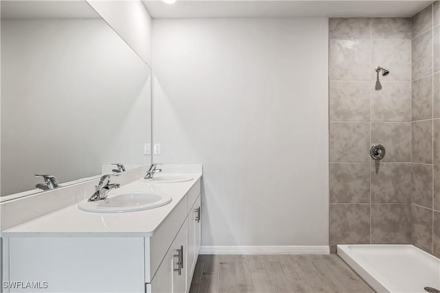 bathroom featuring vanity and tiled shower