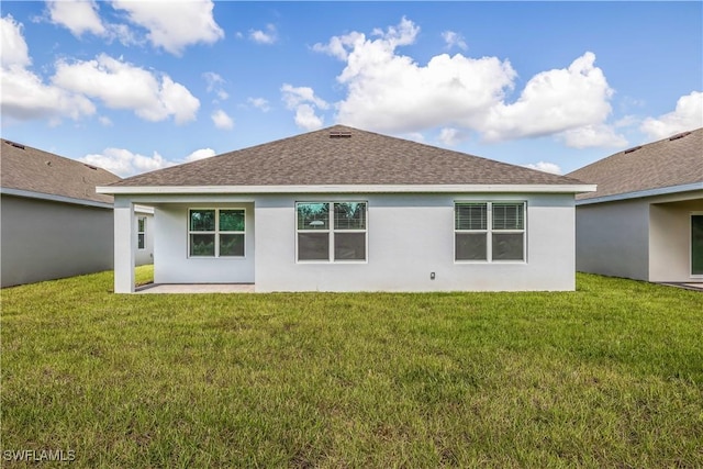 rear view of property featuring a yard