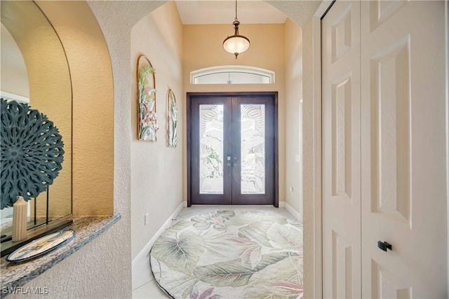 tiled entryway featuring french doors