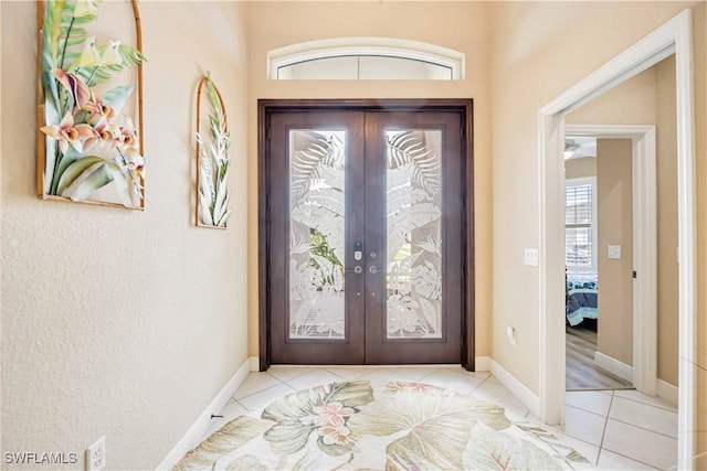 foyer with french doors and light tile patterned flooring