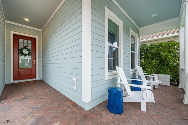 view of exterior entry with a porch