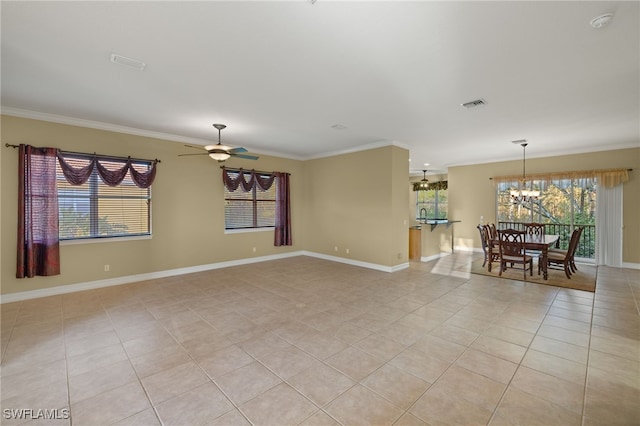 empty room featuring ceiling fan with notable chandelier, crown molding, and light tile patterned flooring