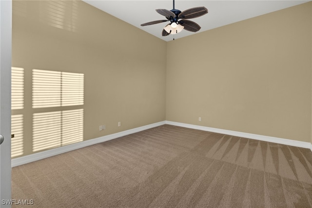 carpeted spare room with ceiling fan