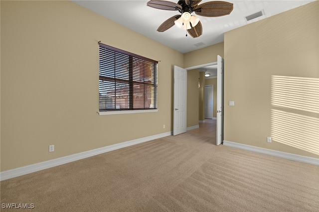 carpeted spare room with ceiling fan