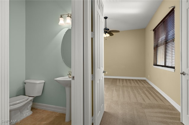 bathroom with toilet, ceiling fan, and sink