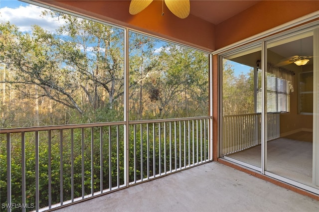 unfurnished sunroom featuring ceiling fan