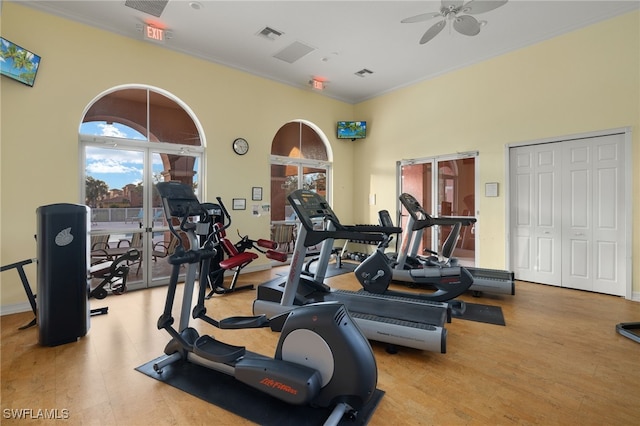 workout area with ceiling fan, light wood-type flooring, and ornamental molding