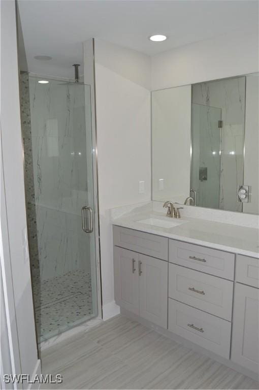 bathroom with vanity and an enclosed shower