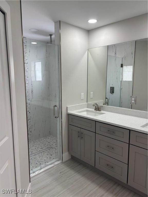 bathroom with vanity and an enclosed shower