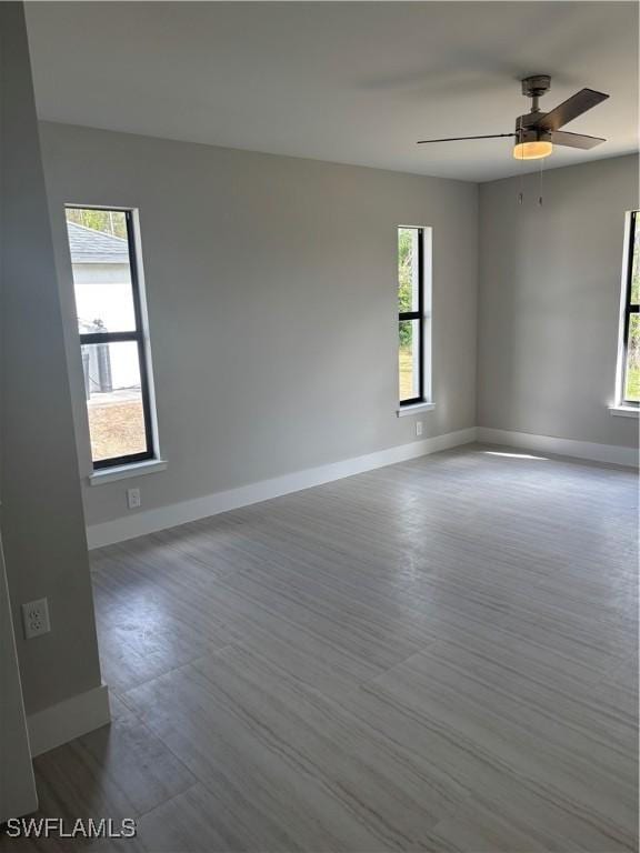 spare room featuring plenty of natural light and ceiling fan