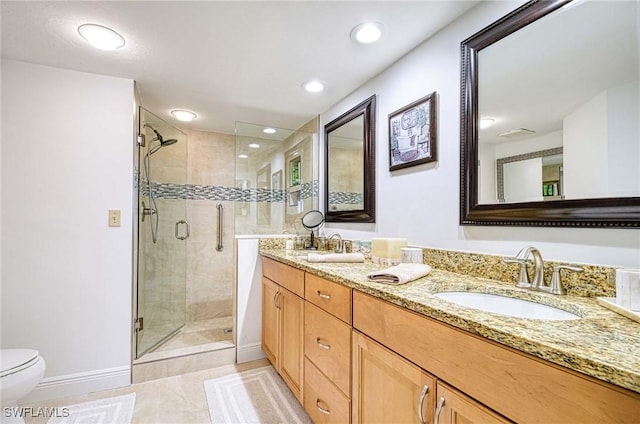 bathroom with an enclosed shower, vanity, toilet, and tile patterned flooring