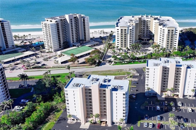 drone / aerial view featuring a water view and a view of the beach