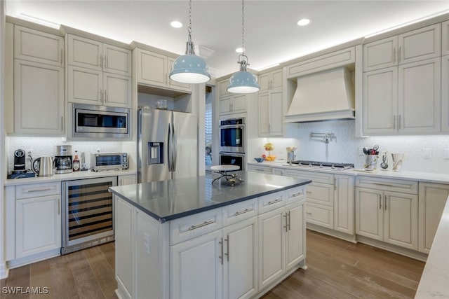 kitchen with custom exhaust hood, wine cooler, decorative backsplash, appliances with stainless steel finishes, and decorative light fixtures