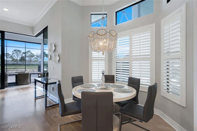 dining area with ornamental molding and an inviting chandelier