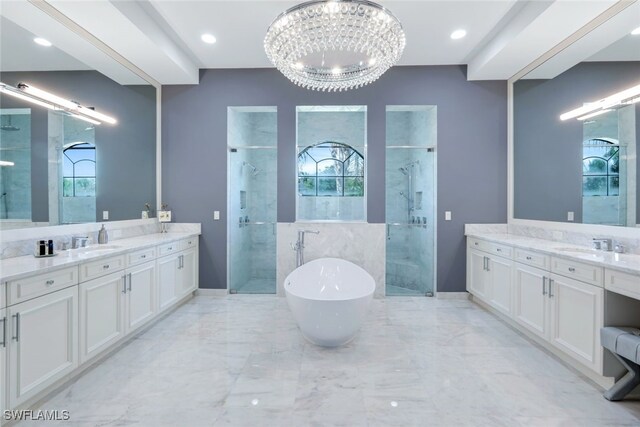 bathroom with vanity, shower with separate bathtub, and an inviting chandelier