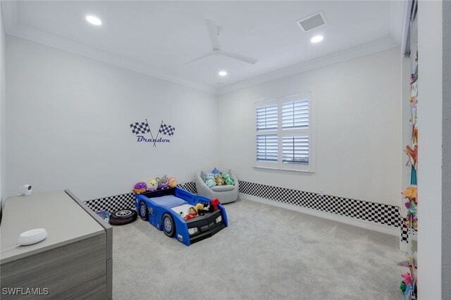 carpeted bedroom with ceiling fan and ornamental molding