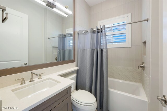 full bathroom featuring vanity, toilet, and shower / tub combo