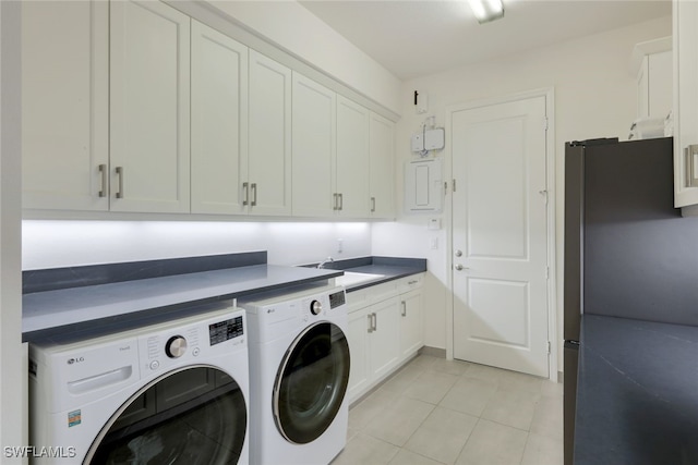 clothes washing area featuring cabinets, independent washer and dryer, sink, and light tile patterned flooring