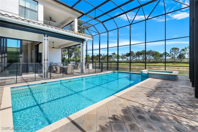 view of pool with a lanai, ceiling fan, a patio, and an in ground hot tub