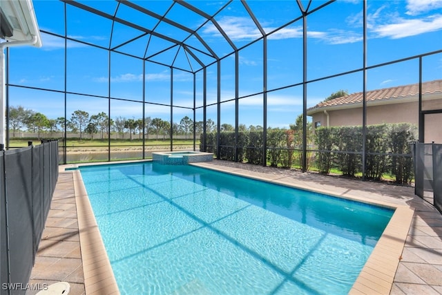 view of swimming pool featuring a lanai and an in ground hot tub