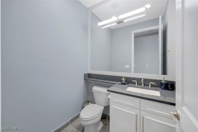 bathroom with tile patterned floors, vanity, and toilet