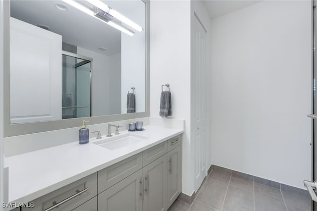 bathroom featuring tile patterned flooring and vanity