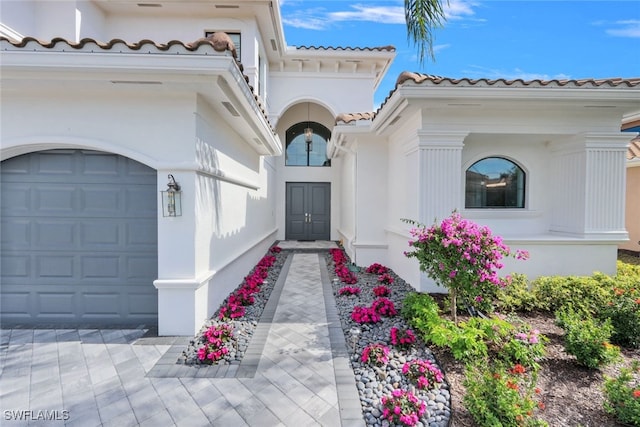 view of exterior entry featuring a garage