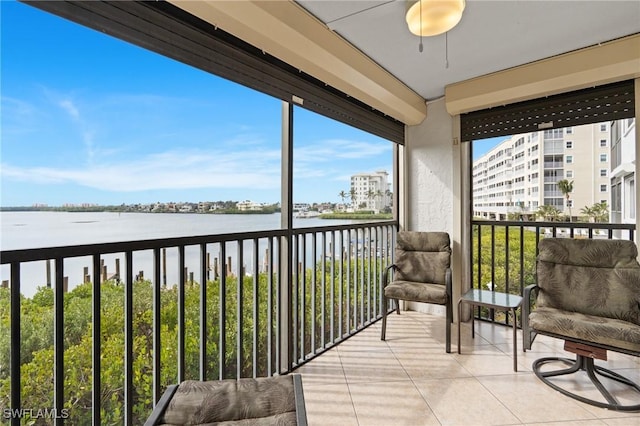 sunroom / solarium with a water view