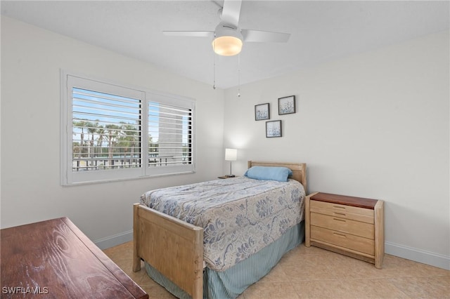 tiled bedroom featuring ceiling fan