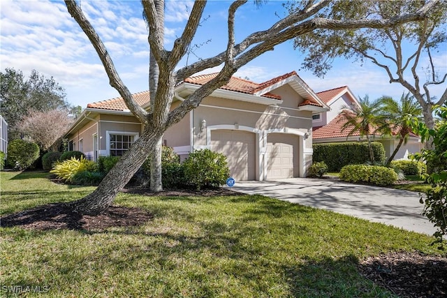 view of front of property with a tile roof, stucco siding, a garage, driveway, and a front lawn