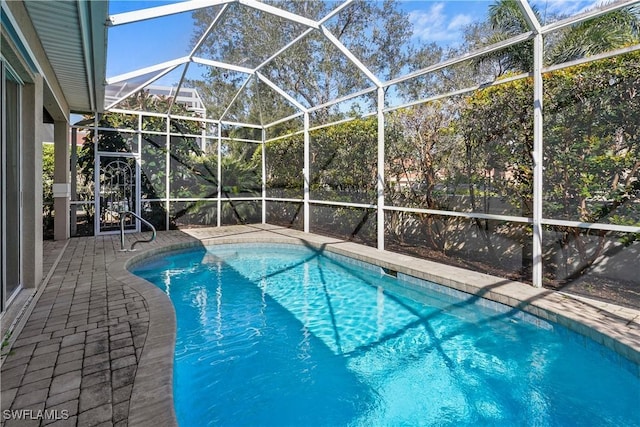 outdoor pool featuring a lanai and a patio