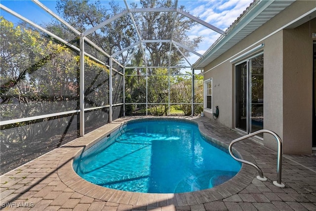 pool featuring a patio and glass enclosure