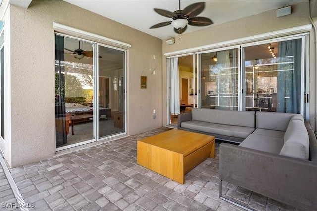 view of patio / terrace featuring ceiling fan and an outdoor living space