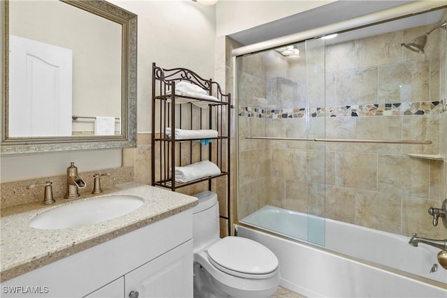 full bathroom with toilet, vanity, and enclosed tub / shower combo
