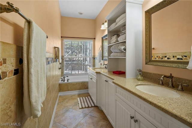 bathroom with vanity, tile patterned flooring, and a bath