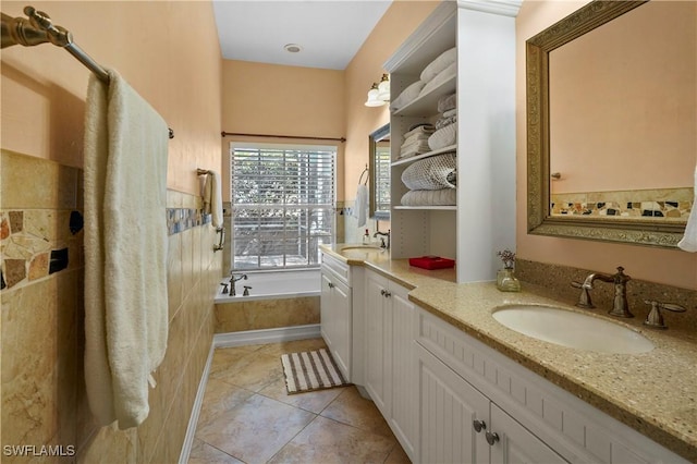 full bathroom featuring tile patterned floors, a garden tub, and vanity