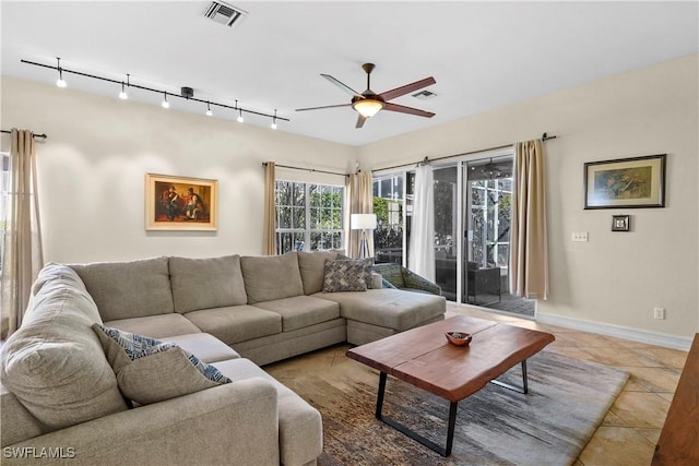 living room with a ceiling fan, baseboards, tile patterned floors, and track lighting