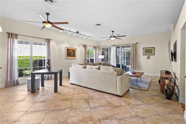living area with a ceiling fan, baseboards, light tile patterned flooring, and rail lighting
