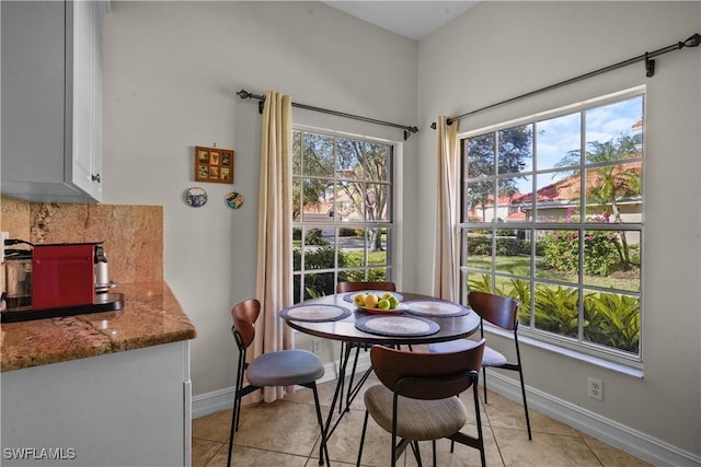 dining room with baseboards and light tile patterned flooring
