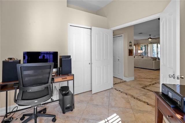 office featuring baseboards, light tile patterned floors, and a ceiling fan