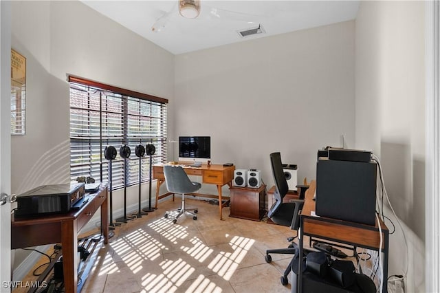 home office featuring light tile patterned flooring, visible vents, and baseboards