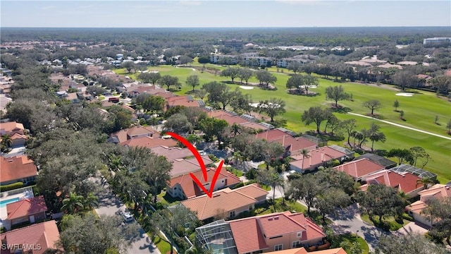 aerial view of residential area featuring a golf course